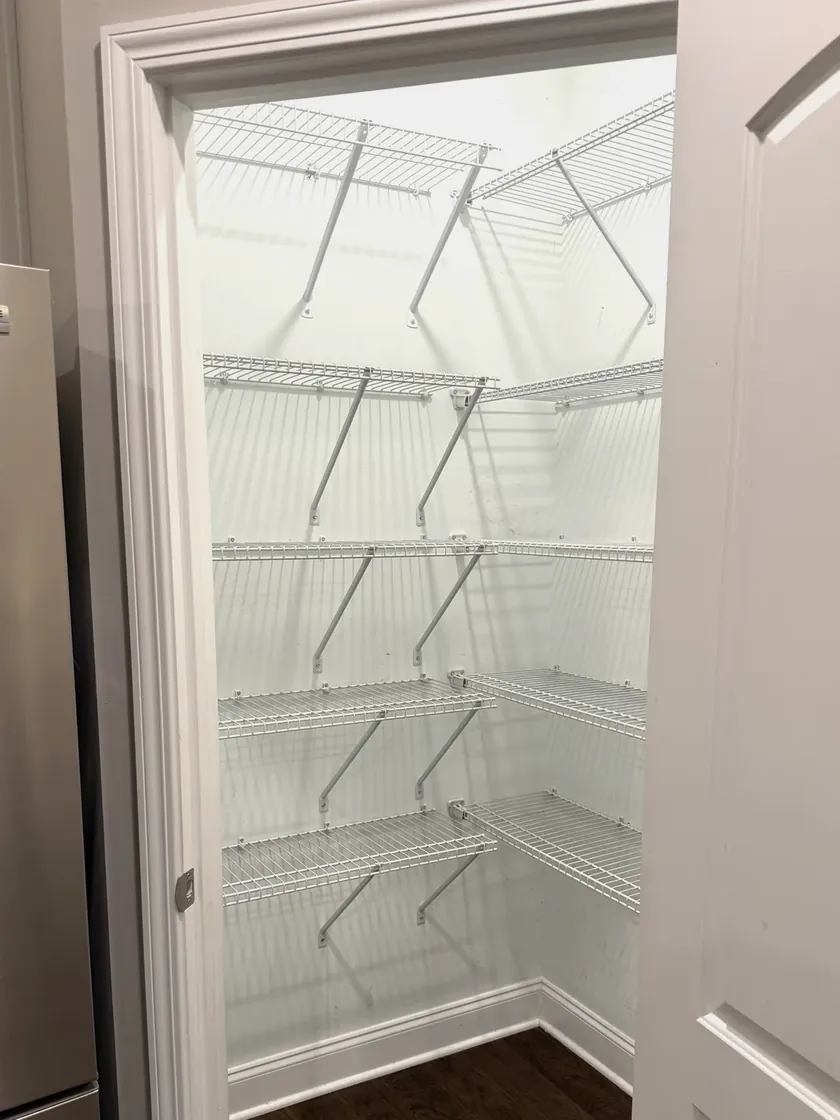 Before: builder-grade wire shelving in the Fraleys' pantry