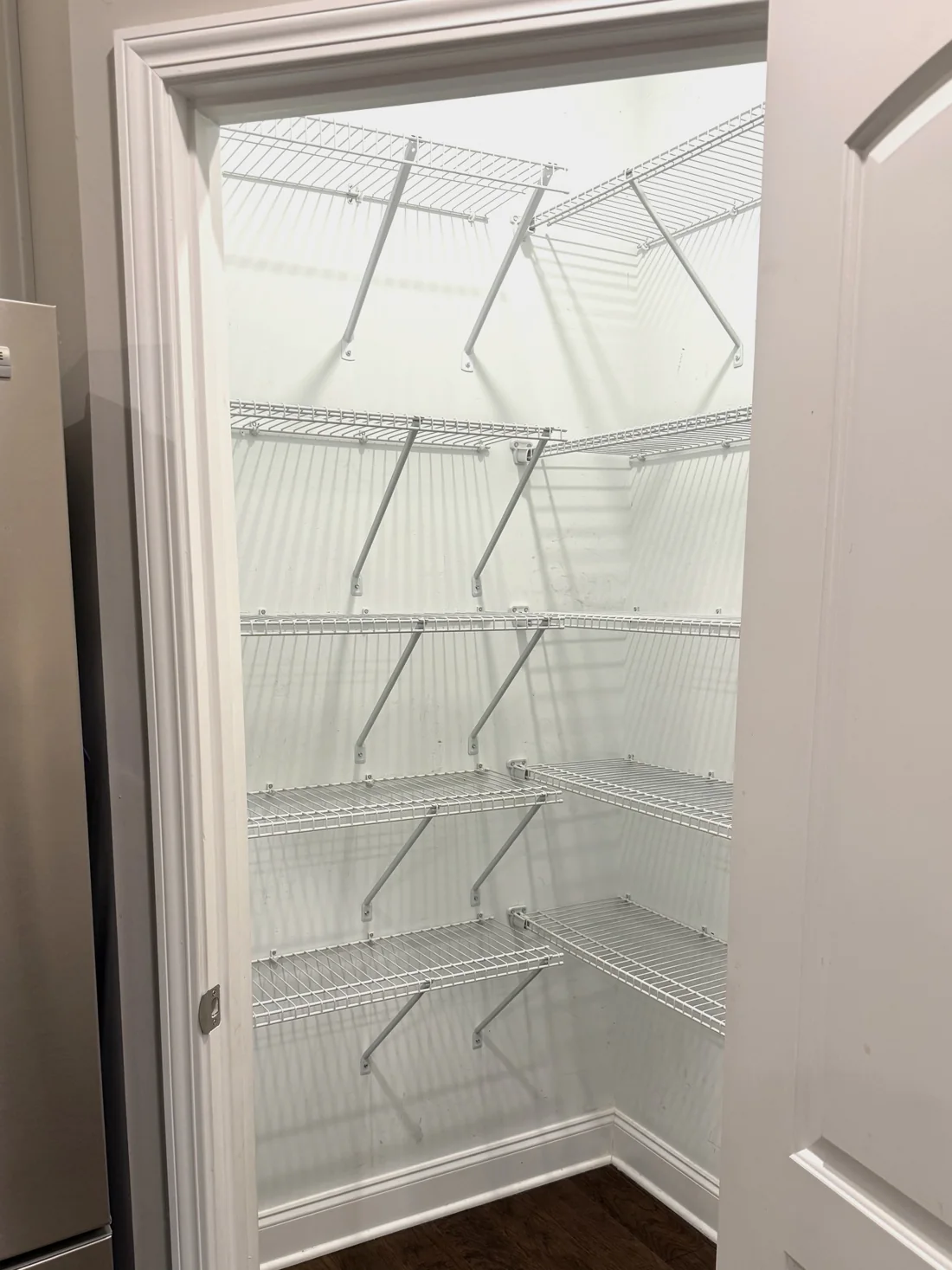 Before: builder-grade wire shelving in the Fraleys' pantry